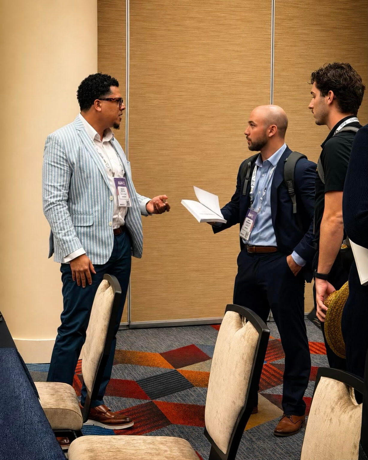 Devon Euring in conversation with attendees at a conference